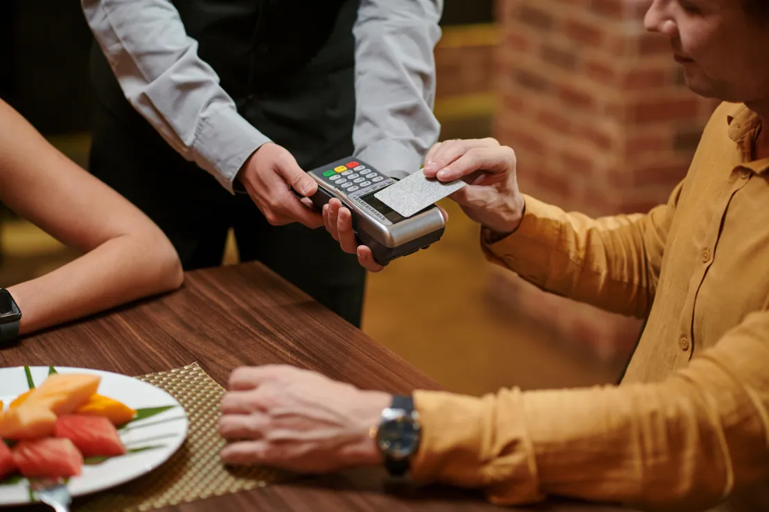 Man Paying In A Restaurant With His Credit Card