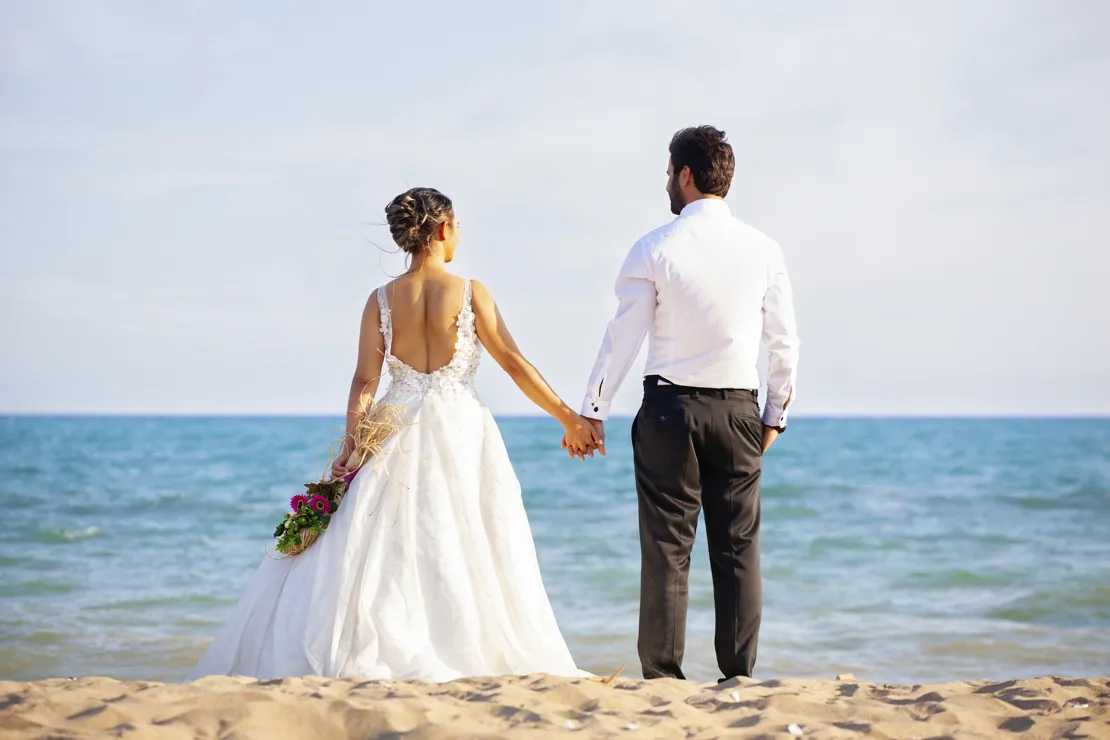 Couple Holding Hands By The Ocean