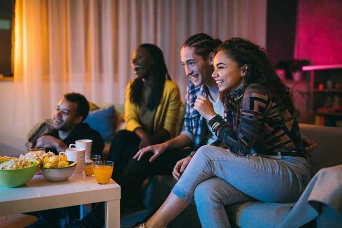 group-of-young-friends-watching-television-together image