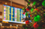Christmas tree at the airport, in front of a departures board