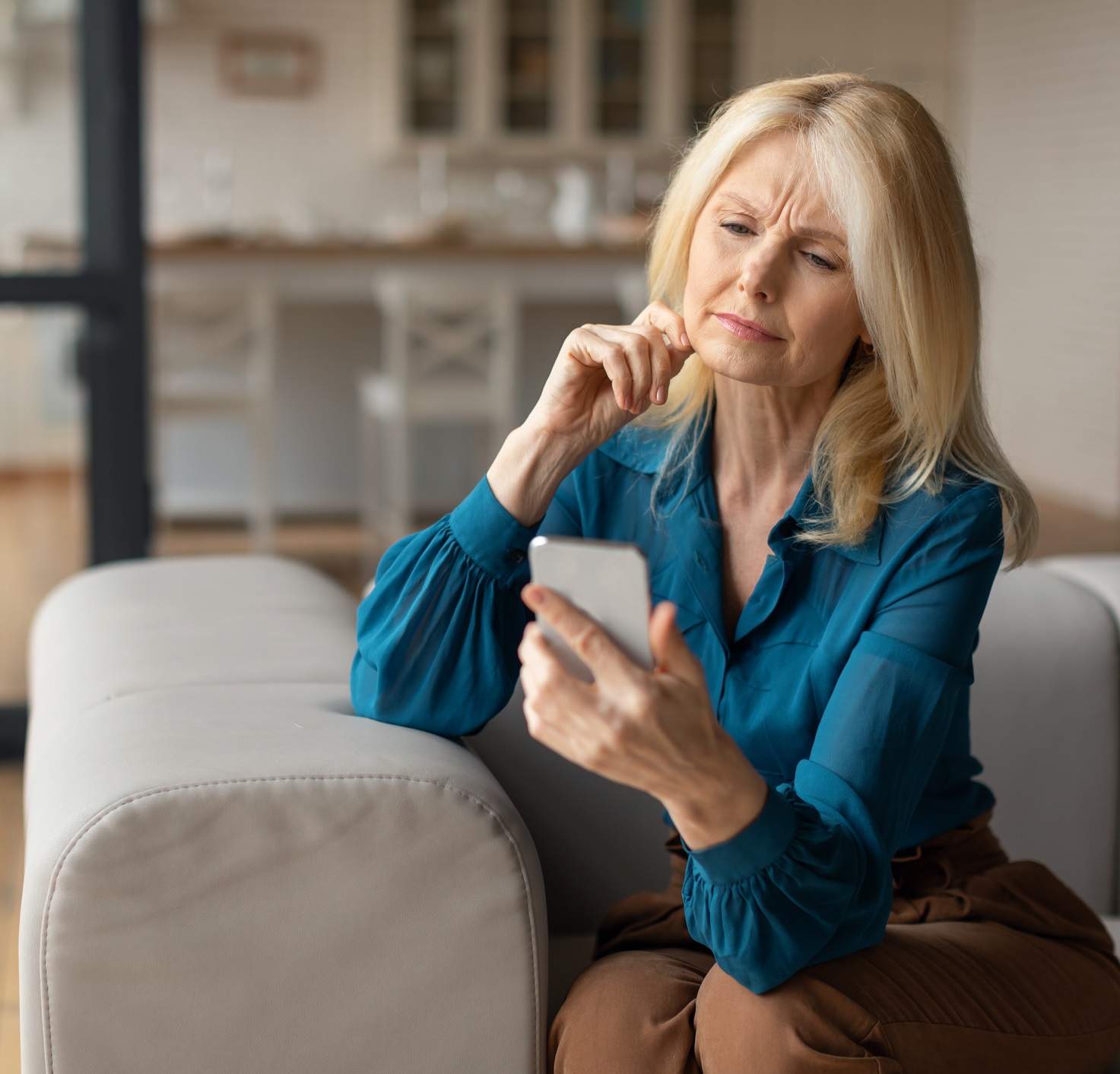 Woman Looking Concerned On Her Phone