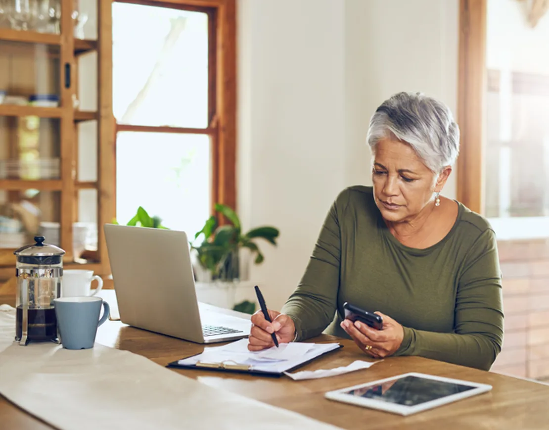 Shot Of A Mature Woman Going Through Paperwork At Home