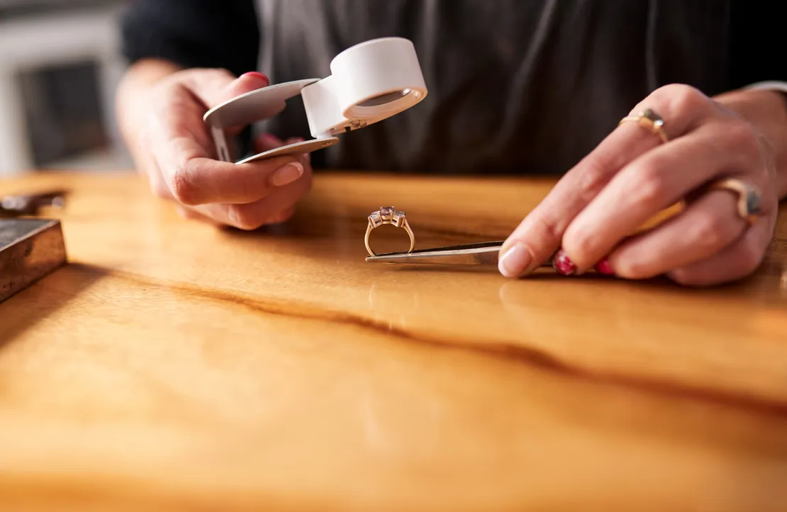 Jeweller Inspecting A Diamond Ring