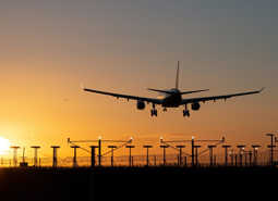 Plane Taking Off At Sunset