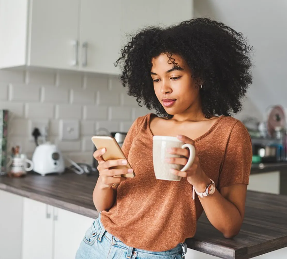 Woman Looking At Her Phone Considering Reporting Fraud
