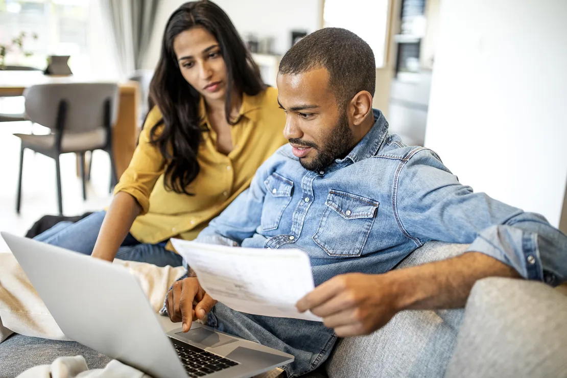 Two People Looking At Bank Statements