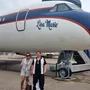 A lady and her partner posing by the Lisa Marie plane